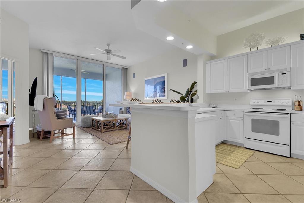 450 Launch Circle, Unit 602 Naples, FL 34108 - Photo 7 of 27 a kitchen with a sink cabinets and window