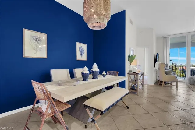 a view of a dining room with furniture and chandelier