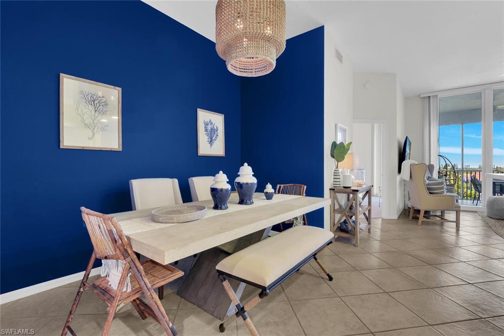 450 Launch Circle, Unit 602 Naples, FL 34108 - Photo 8 of 27 a view of a dining room with furniture and chandelier
