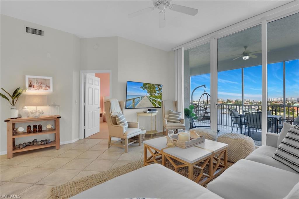 450 Launch Circle, Unit 602 Naples, FL 34108 - Photo 10 of 27 a living room with furniture and a large window