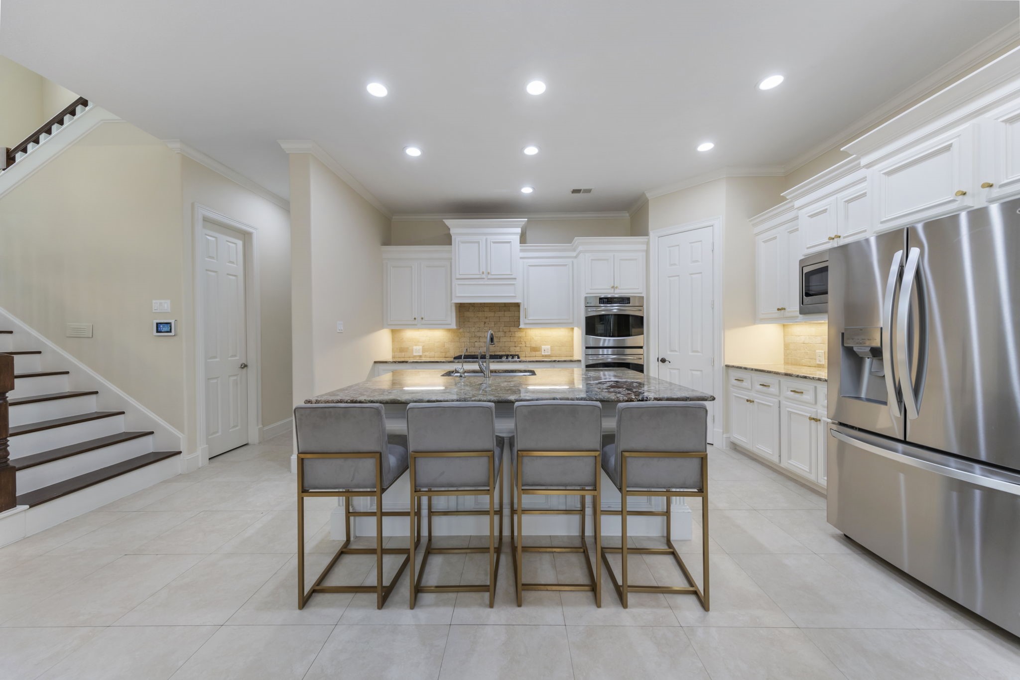 90 West Horizon Ridge Place Spring, TX 77381 - Photo 14 of 36 a kitchen with kitchen island wooden cabinets and stainless steel appliances