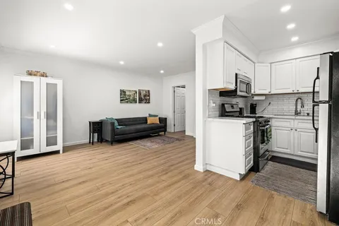 a kitchen with cabinets and wooden floor