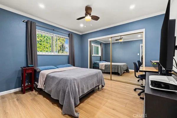 a spacious bedroom with a bed and a chandelier