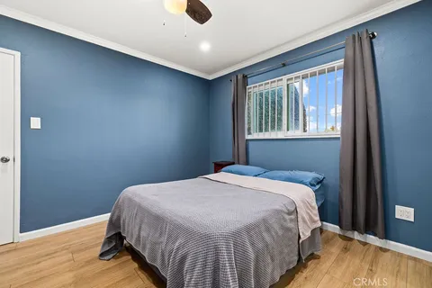 a bed sitting in a bedroom next to a window