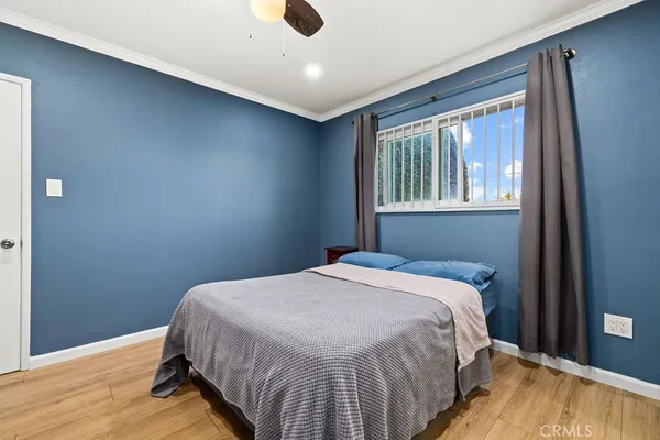 a bed sitting in a bedroom next to a window