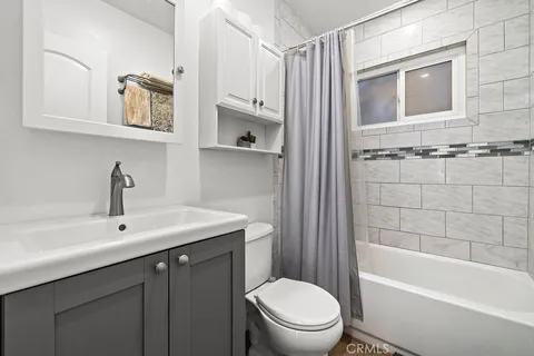 a bathroom with a sink a toilet and bathtub