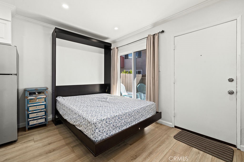 5050 Linden Avenue, Unit 62 Long Beach, CA 90805 - Photo 19 of 37 a bedroom with a bed and a dresser with wooden floor