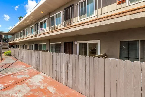 a view of a house with a wooden fence