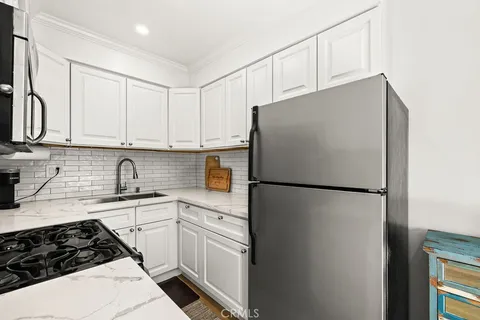 a white refrigerator freezer sitting inside of a kitchen