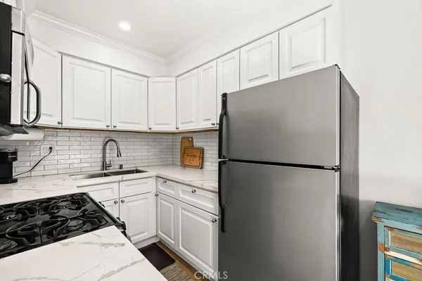 a white refrigerator freezer sitting inside of a kitchen