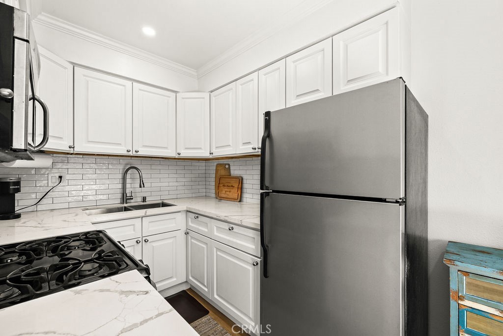 5050 Linden Avenue, Unit 62 Long Beach, CA 90805 - Photo 9 of 37 a white refrigerator freezer sitting inside of a kitchen