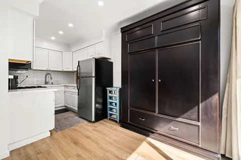 a kitchen with a refrigerator and a stove top oven