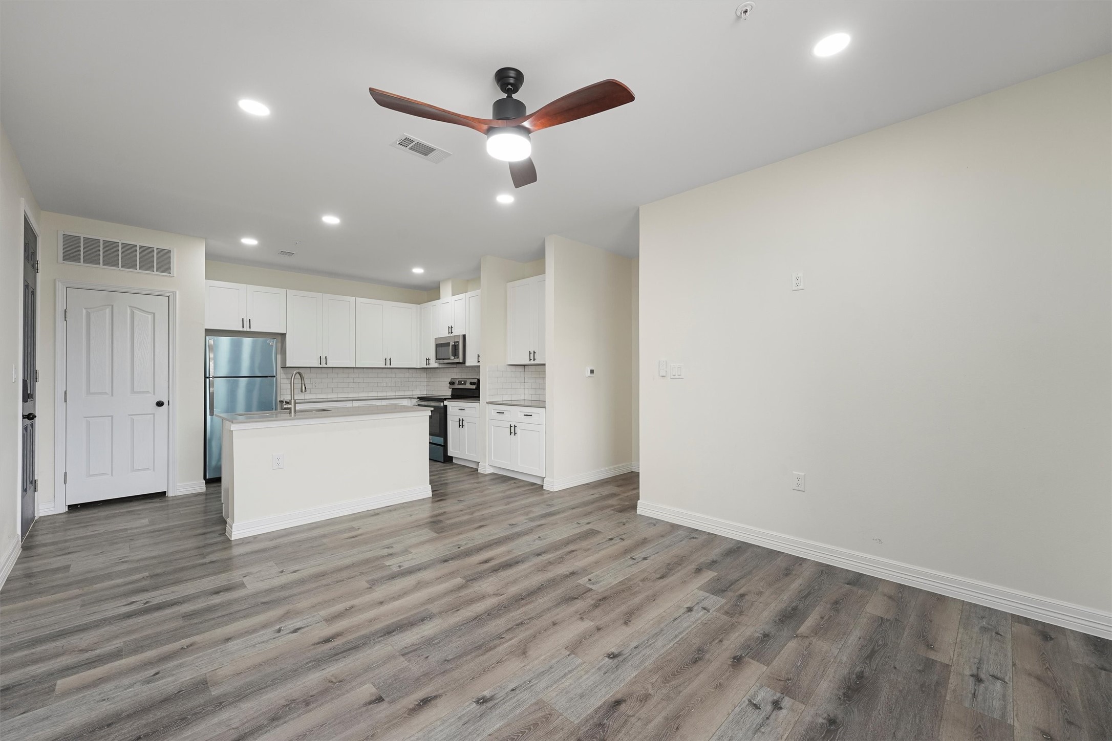 2130 Aldine Mail Rte Road, Unit B102 Houston, TX 77039 - Photo 3 of 9 a view of kitchen with wooden floor and window