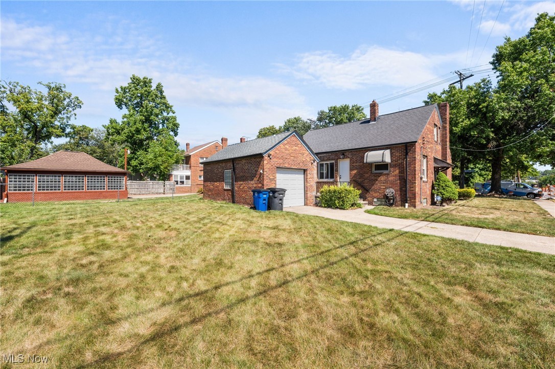 18122 Nottingham Road Cleveland, OH 44119 - Photo 29 of 29 View of back of house featuring a chimney, brick siding, and concrete driveway