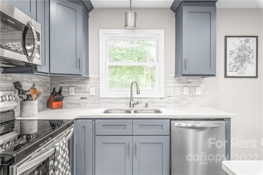 3932 Slagle Drive Charlotte, NC 28215 - Photo 13 of 26 a kitchen with stainless steel appliances granite countertop a sink stove and cabinets