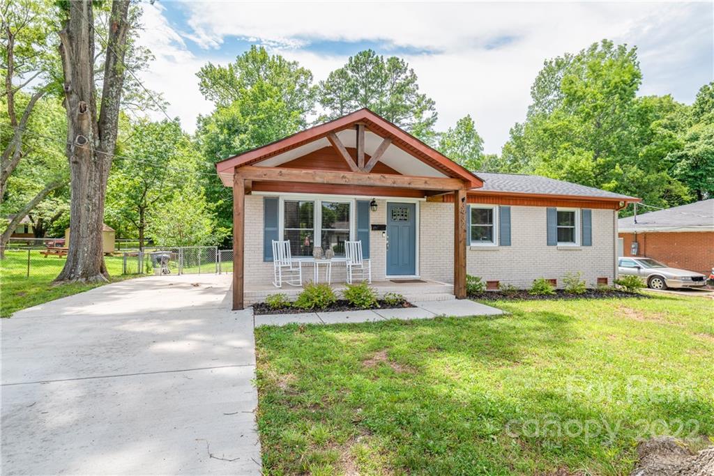 3932 Slagle Drive Charlotte, NC 28215 - Photo 2 of 26 a front view of a house with a yard and trees