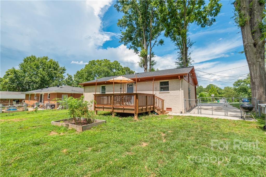 3932 Slagle Drive Charlotte, NC 28215 - Photo 22 of 26 a view of a house with a yard and sitting area