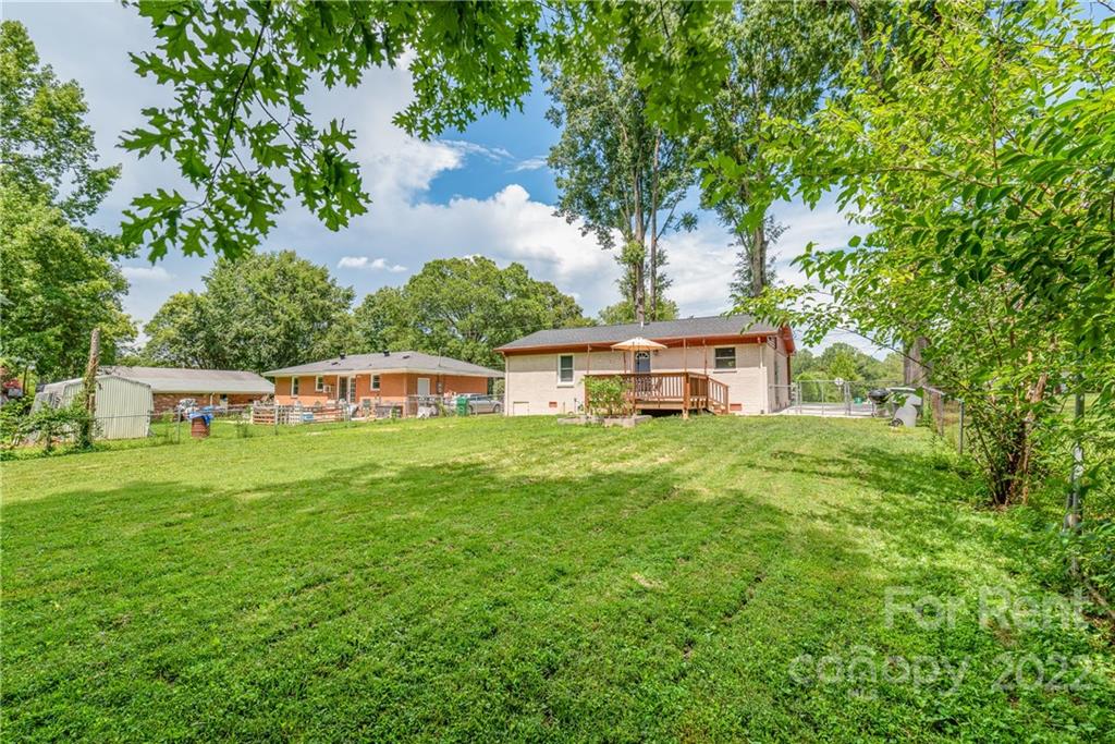 3932 Slagle Drive Charlotte, NC 28215 - Photo 23 of 26 a front view of a house with a garden