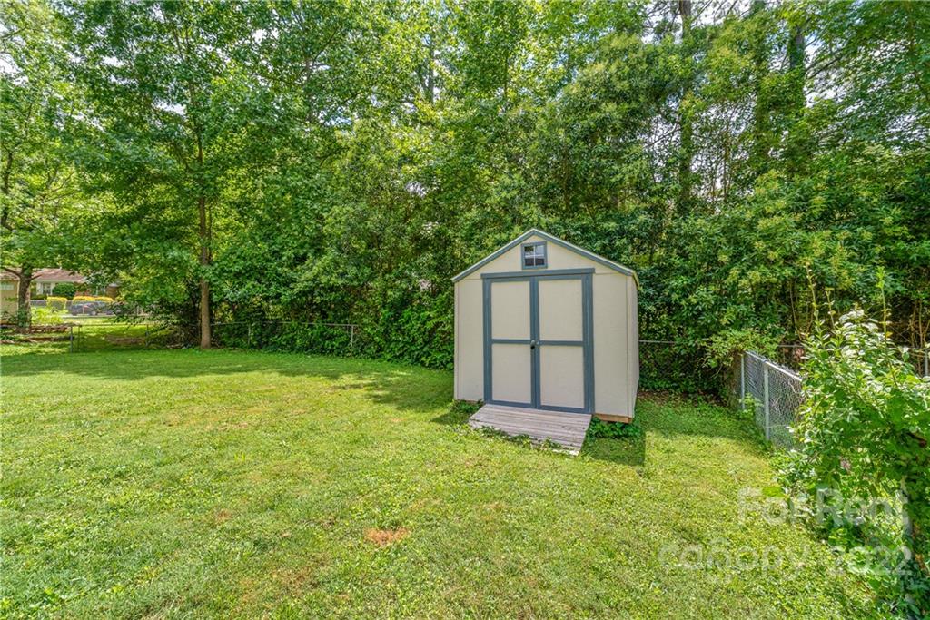 3932 Slagle Drive Charlotte, NC 28215 - Photo 24 of 26 a house with green field in front of it