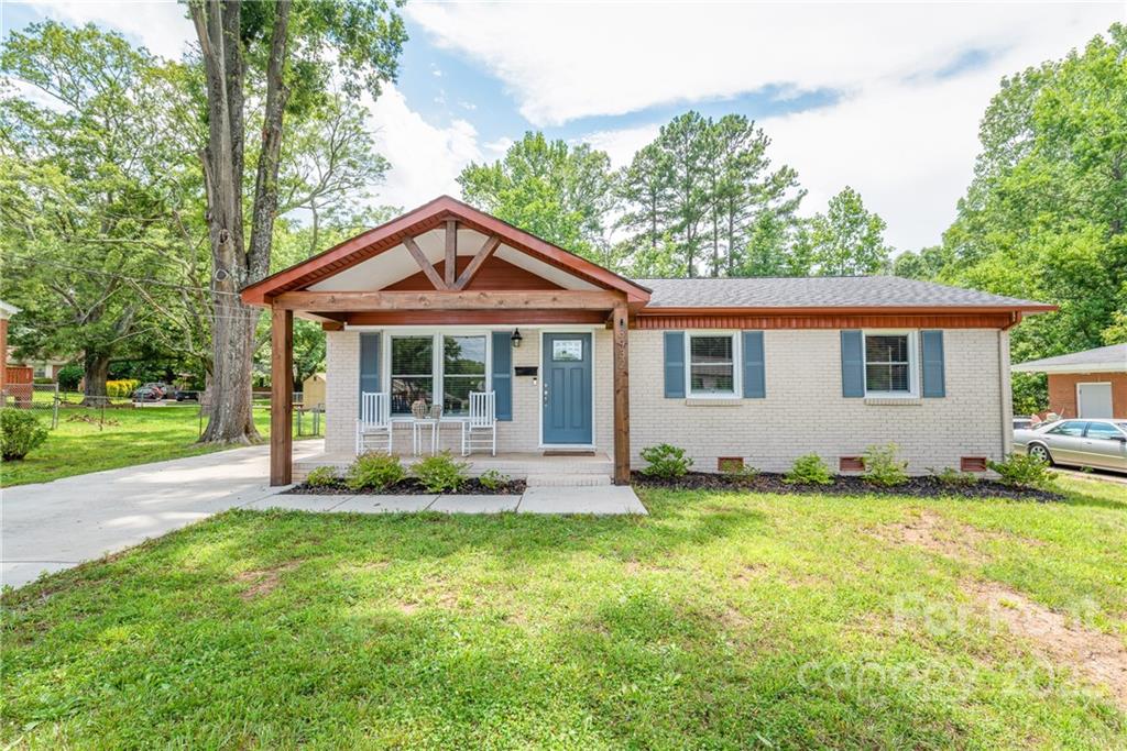 3932 Slagle Drive Charlotte, NC 28215 - Photo 3 of 26 a front view of a house with a garden and yard
