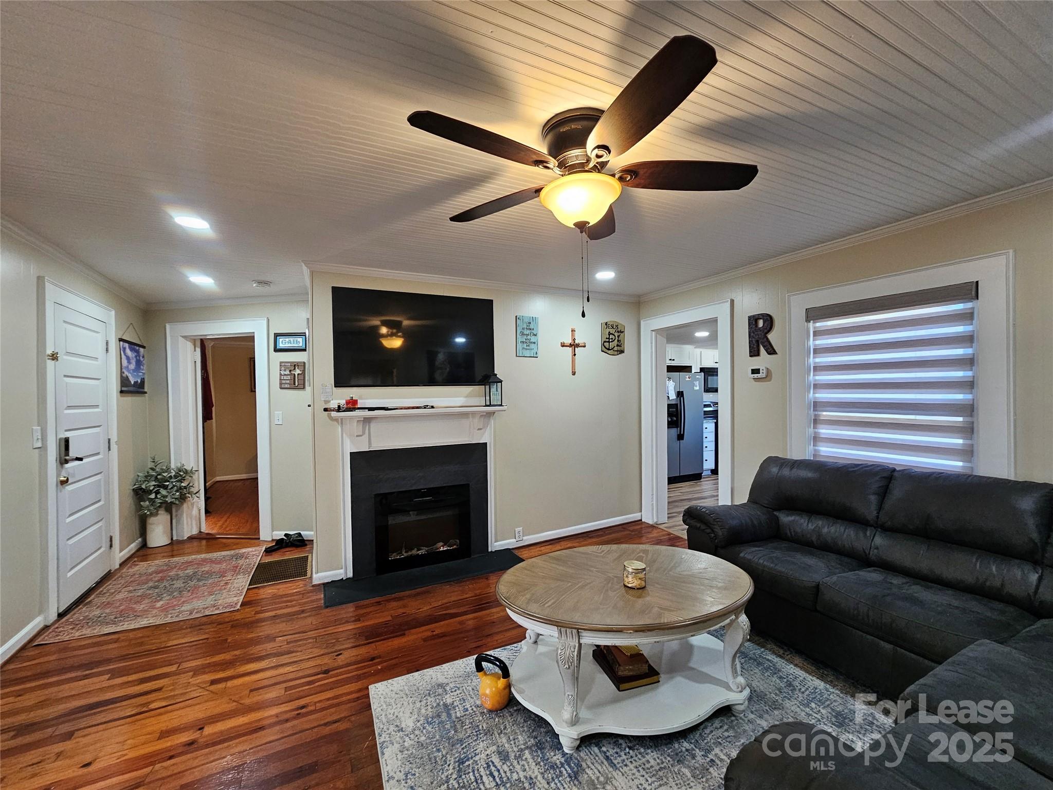208 West Main Street Lawndale, NC 28090 - Photo 3 of 15 a living room with furniture a fireplace and a flat screen tv