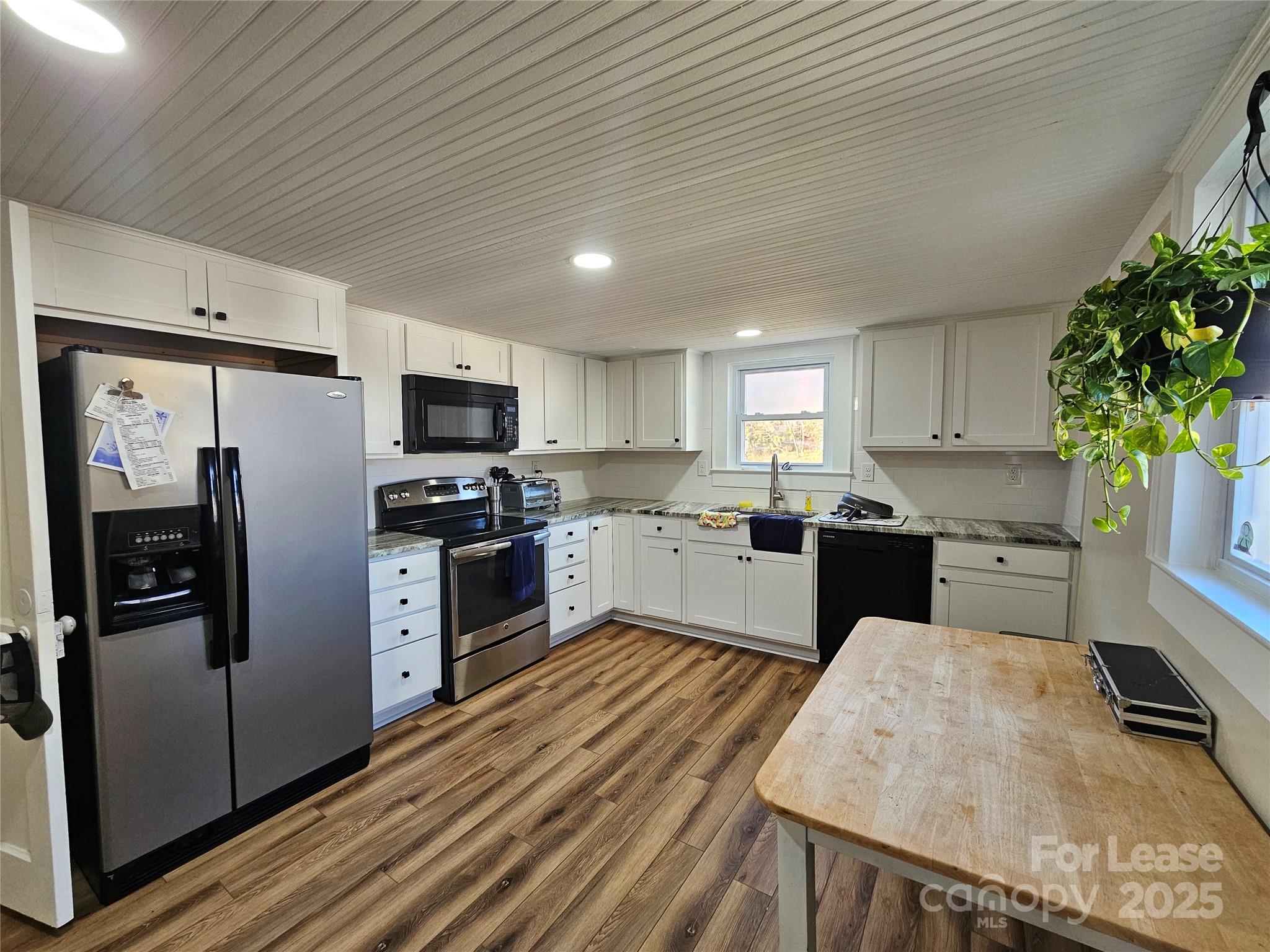 208 West Main Street Lawndale, NC 28090 - Photo 6 of 15 a kitchen with granite countertop stainless steel appliances and white cabinets