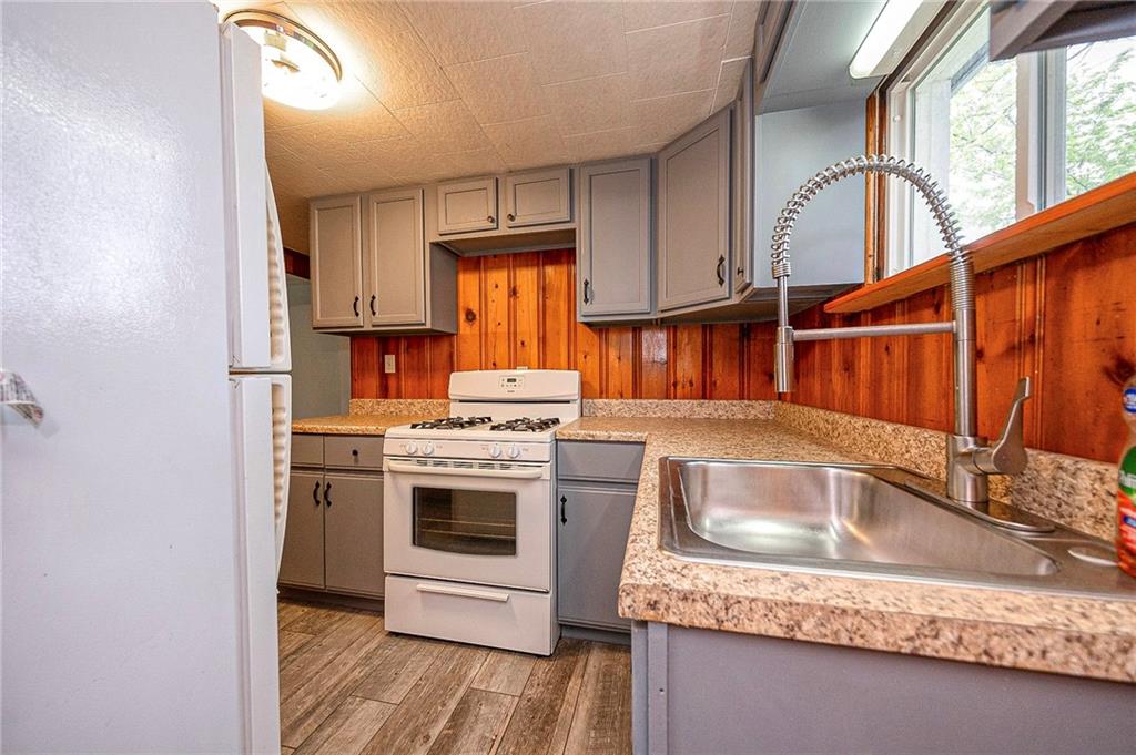 531 Laughlin Avenue Pittsburgh, PA 15210 - Photo 10 of 35 a kitchen with stainless steel appliances granite countertop a sink stove and cabinets