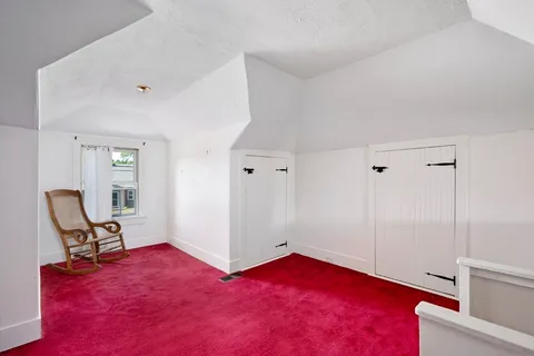 a view of a livingroom with wooden floor and furniture