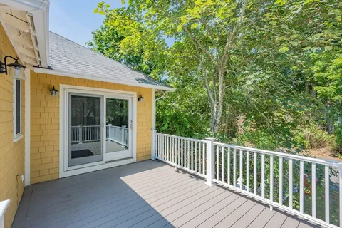 a view of backyard with deck and wooden floor