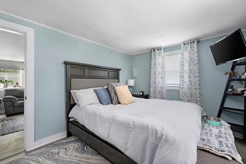 a bedroom with a bed and a flat screen tv