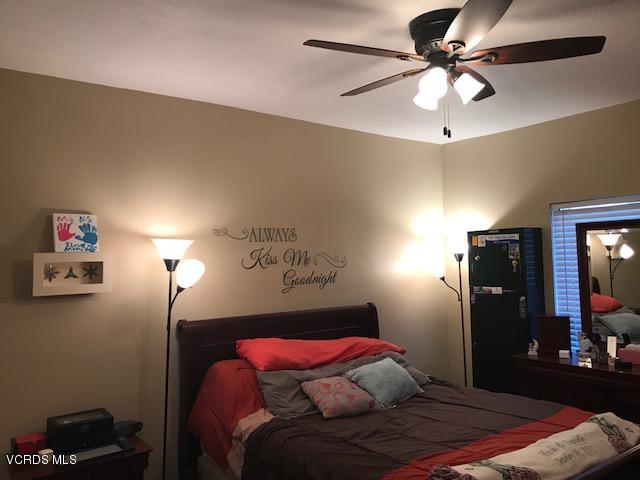 2381 Archwood Lane, Unit 184 Simi Valley, CA 93063 - Photo 12 of 33 a bedroom with a bed and a chandelier