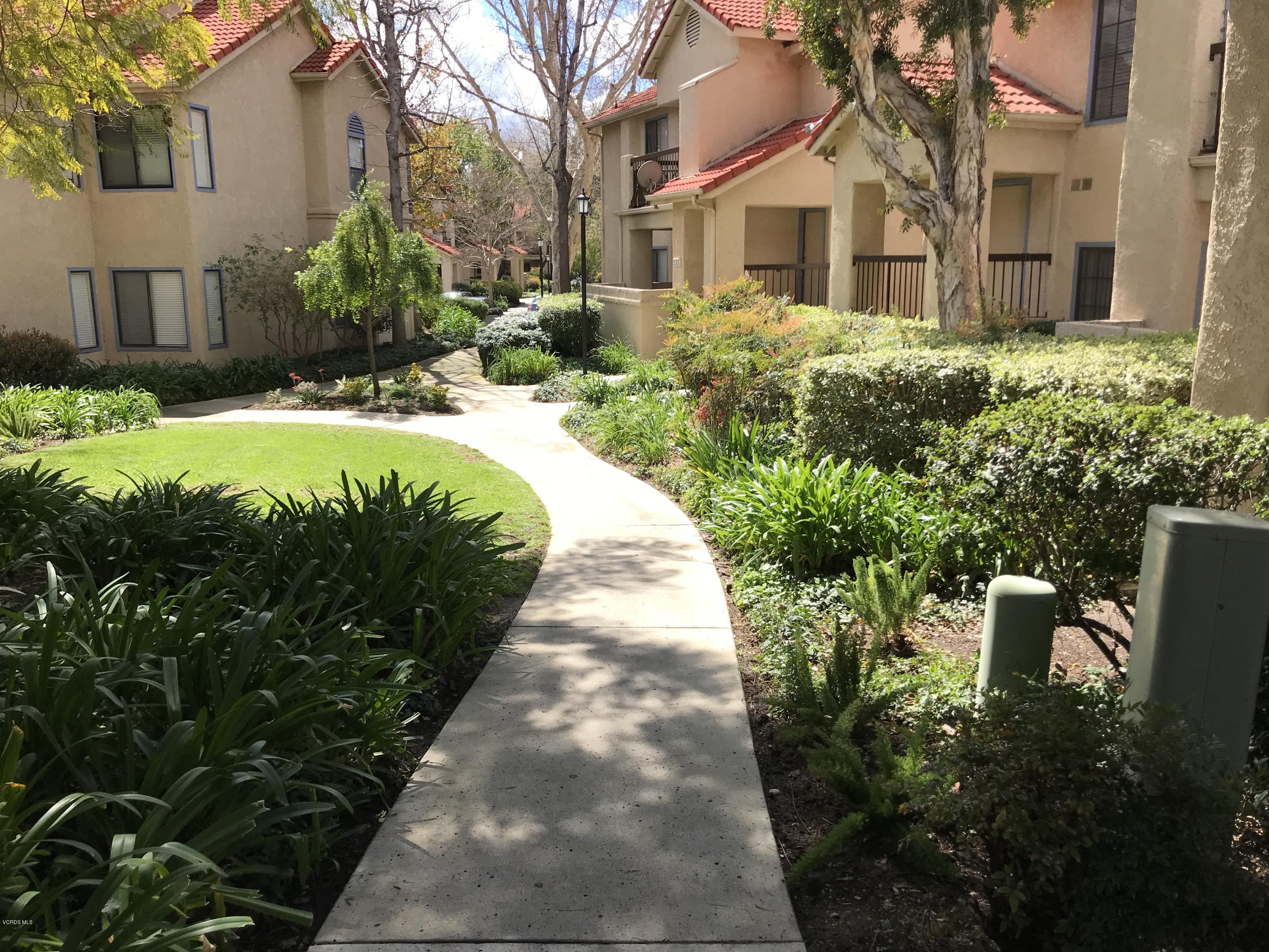2381 Archwood Lane, Unit 184 Simi Valley, CA 93063 - Photo 26 of 33 a front view of a house with a yard and potted plants
