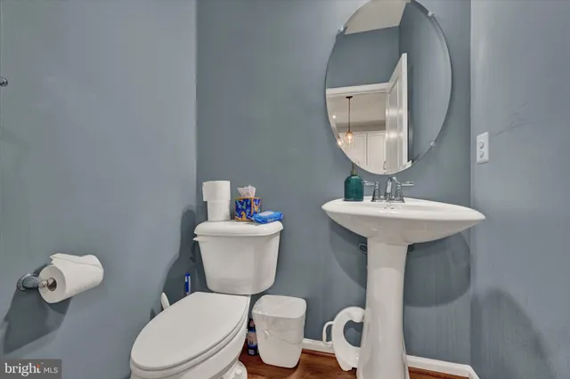 a bathroom with a toilet sink and mirror