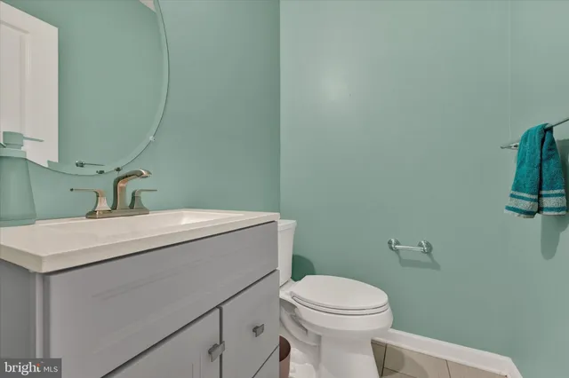 a bathroom with a sink a toilet and mirror