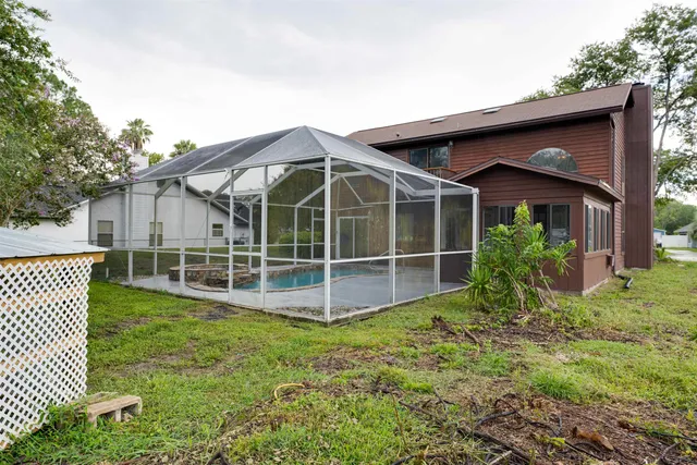 a view of a house with a yard and tree