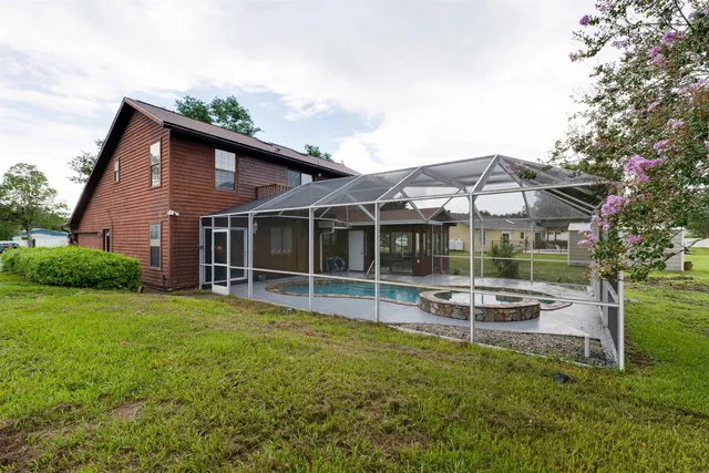 an aerial view of a house with yard