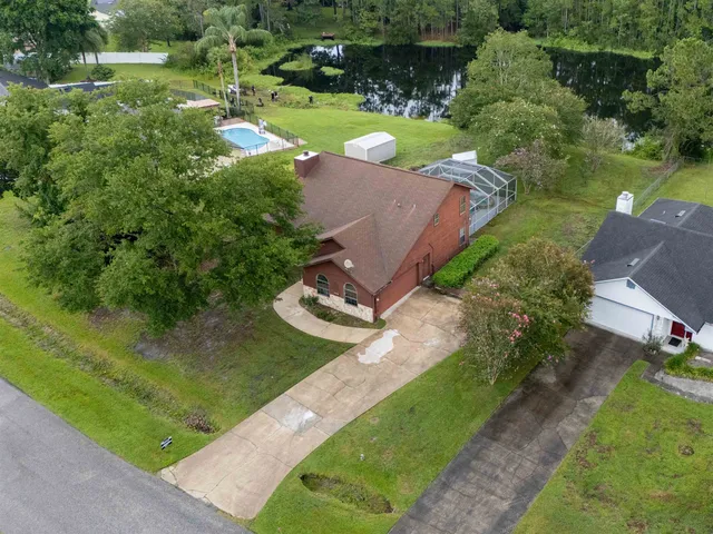 a view of a house with a yard and potted plants