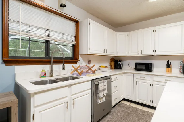 a kitchen with a sink a stove and cabinets