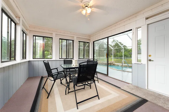 a living room with furniture a fireplace and a large window