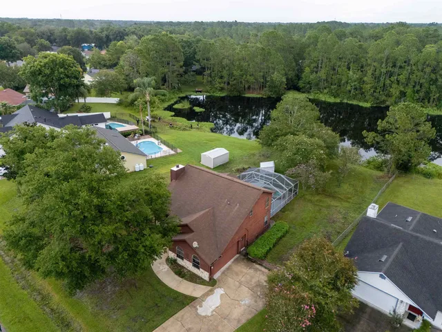 an aerial view of a house with a yard