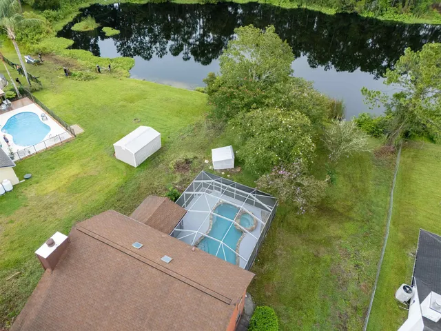 an aerial view of a house with a yard