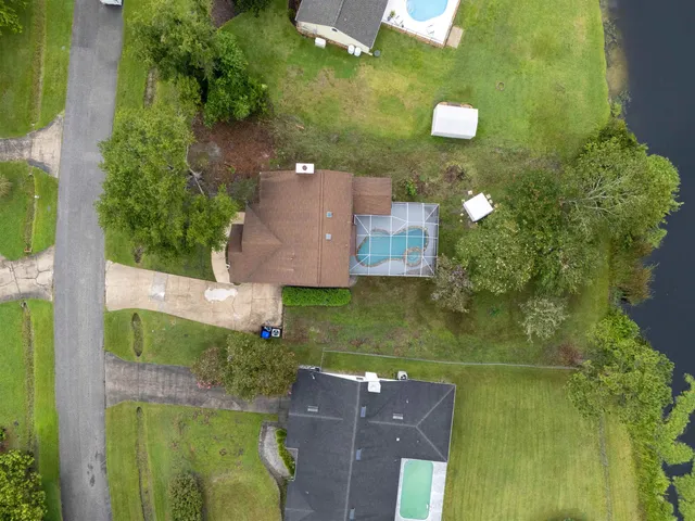 an aerial view of house with yard swimming pool and outdoor seating