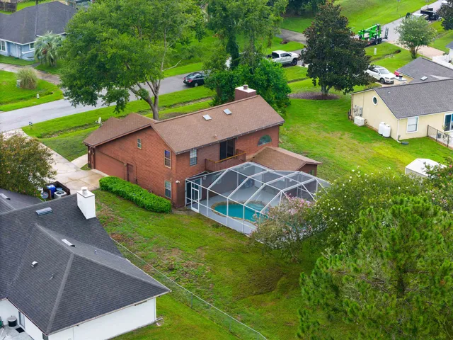 an aerial view of residential houses with outdoor space and river