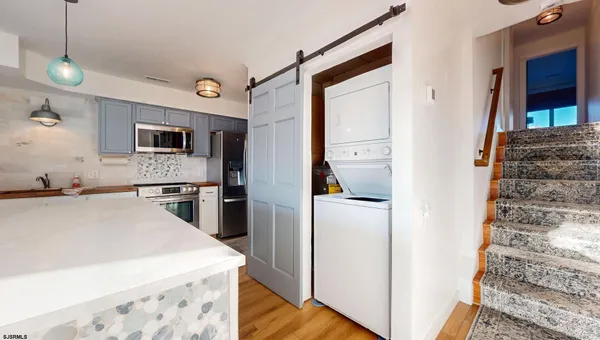 a kitchen with a refrigerator a stove top oven a sink and dishwasher