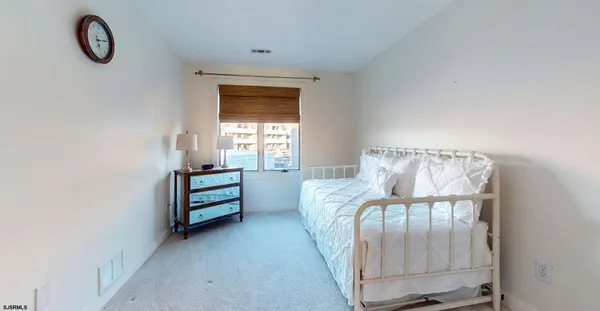 a view of a room that has a bed and a window