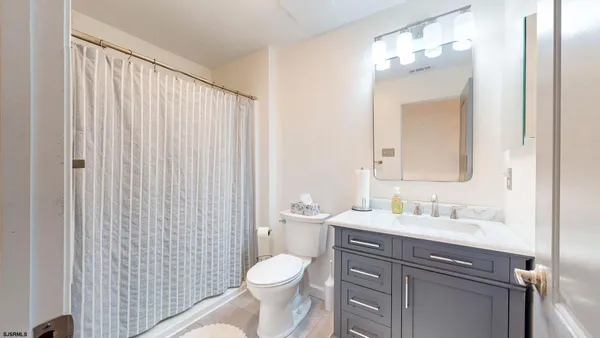 a bathroom with a toilet a sink and a mirror
