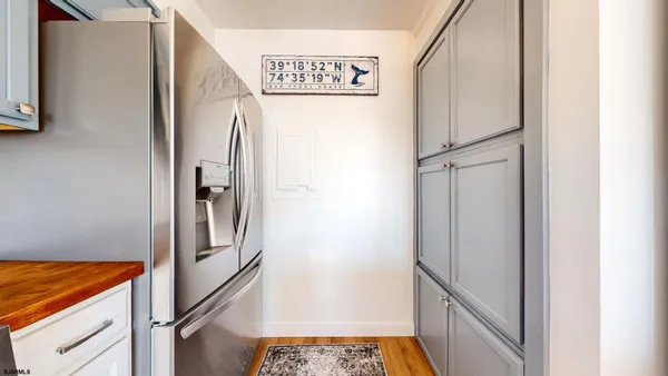 a view of a hallway with a refrigerator