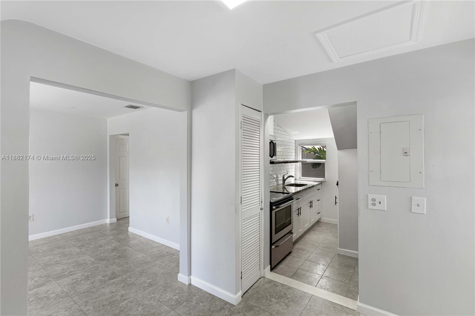 1408 Southwest 19th Terrace, Unit 1410 Miami, FL 33145 - Photo 1 of 12 a view of kitchen with refrigerator and cabinets