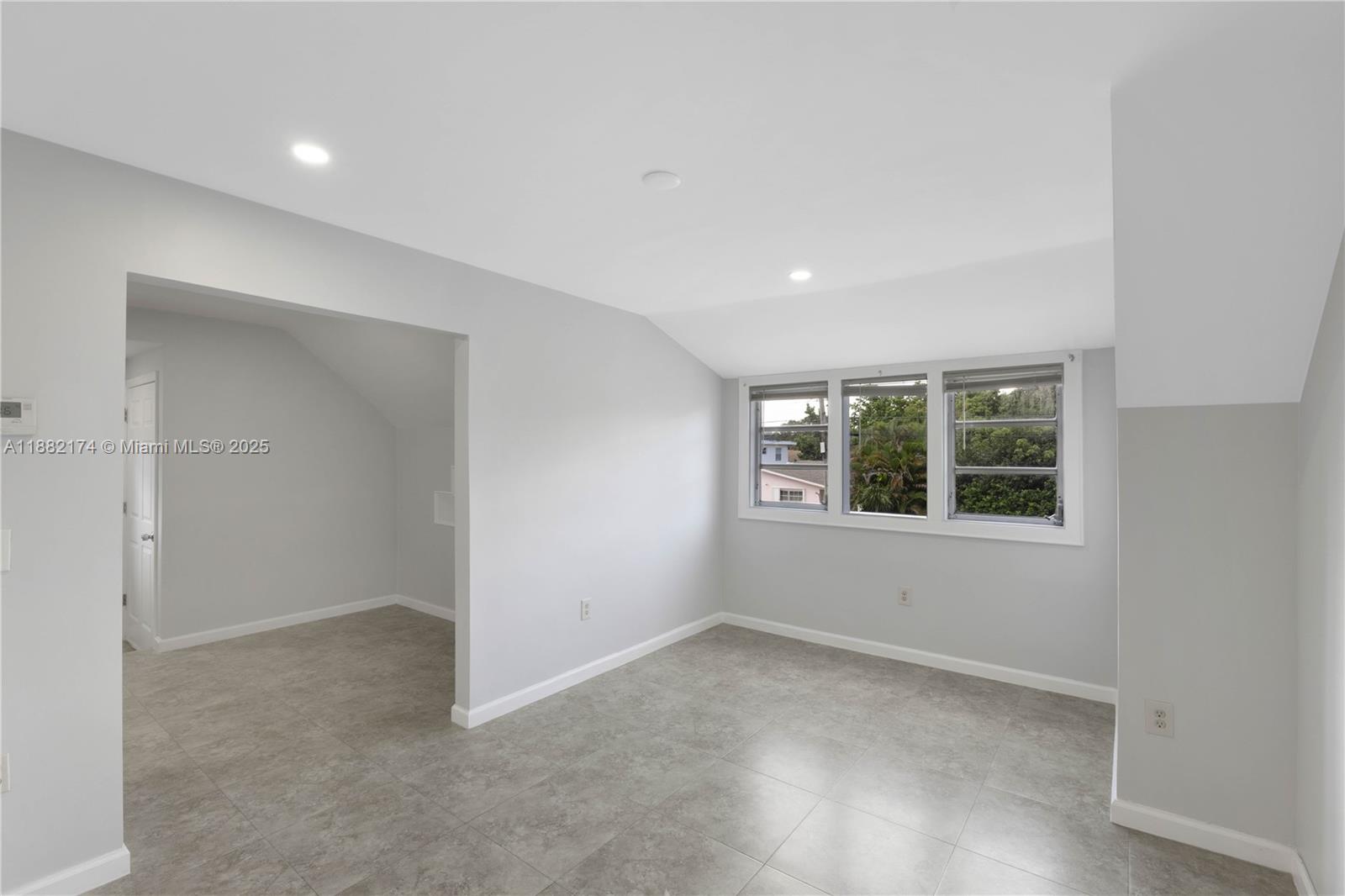1408 Southwest 19th Terrace, Unit 1410 Miami, FL 33145 - Photo 2 of 12 an empty room with a window