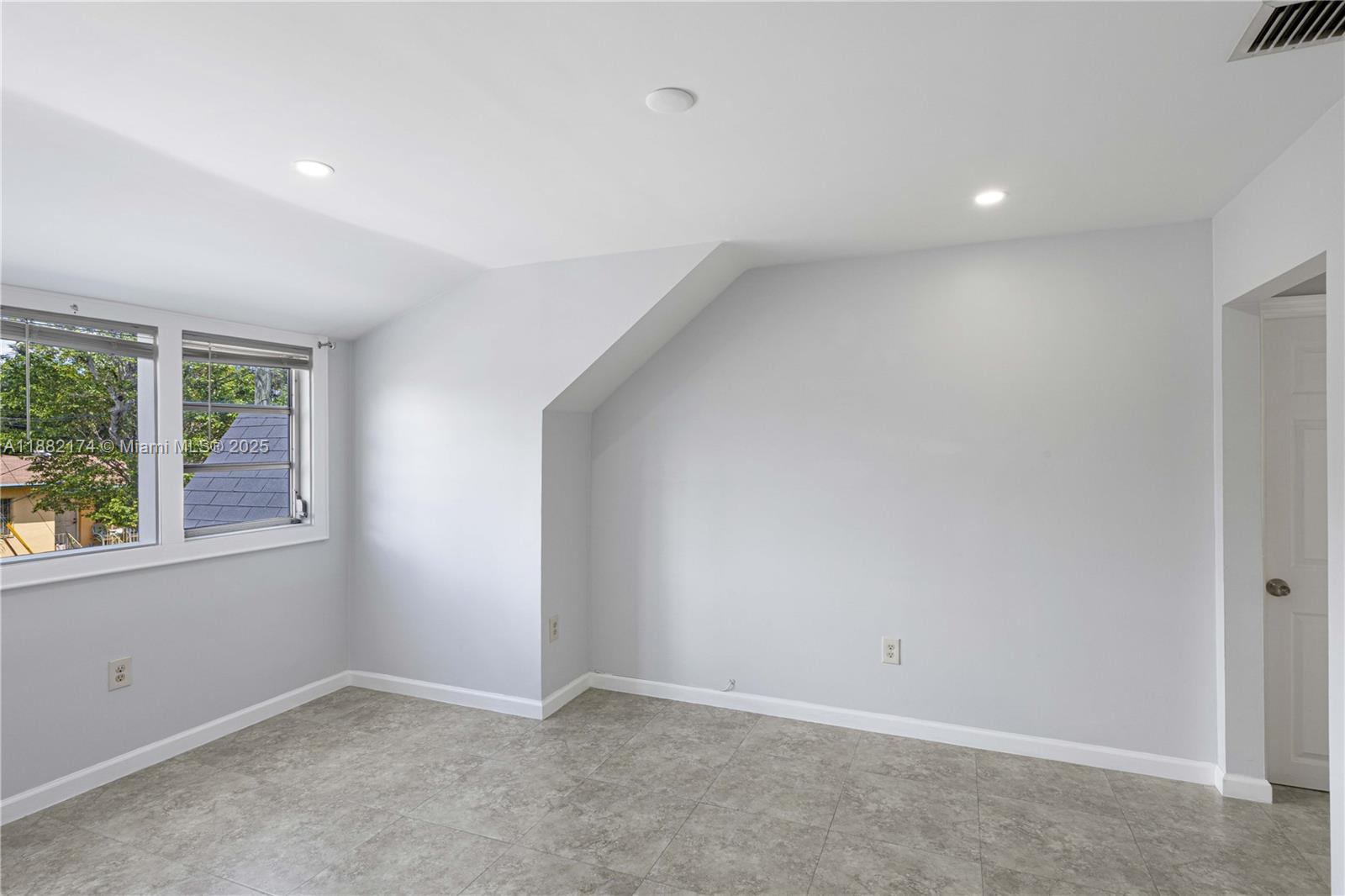 1408 Southwest 19th Terrace, Unit 1410 Miami, FL 33145 - Photo 5 of 12 an empty room with windows